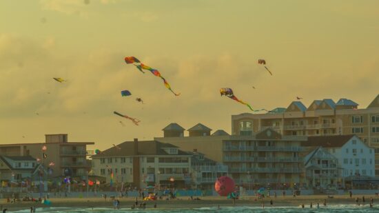 Kites flying outside the Kite Loft in Ocean City, Maryland. OCMD is a resort town in the U.S. state of Maryland between the Atlantic Ocean and Isle of Wight Bay. It features miles of beach and a wooden boardwalk lined with restaurants, shops and hotels. At the boardwalk's southern end, Trimper’s Rides has hosted theme-park attractions for decades. The surrounding waters are active with kayaks and tour boats, some of which journey to popular Assateague Island nearby. This photograph was take in 2020, by Jeff McLain. Please credit appropriately.